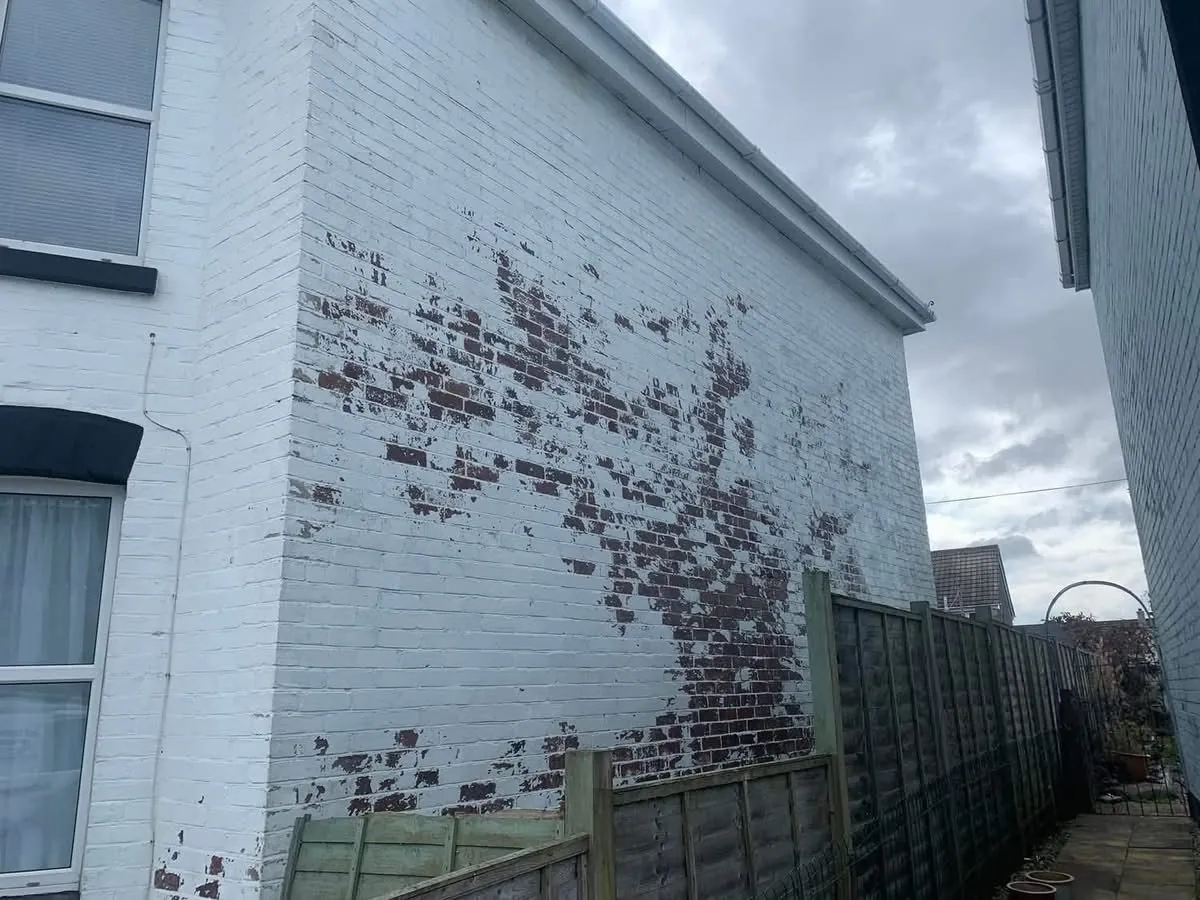 Peeling paint on a brick wall before redecoration in Northam